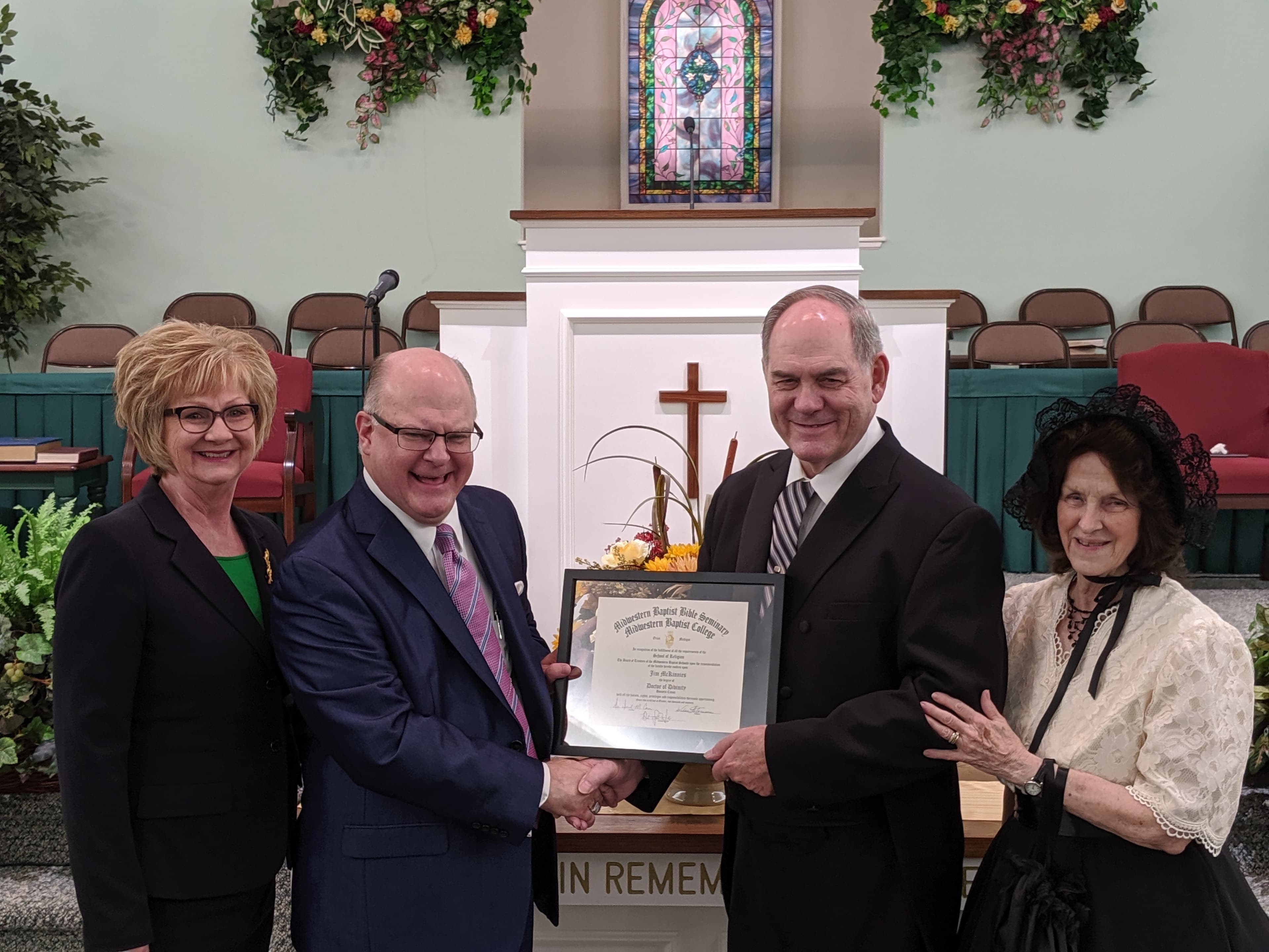 Dr. McKinnies receiving his Doctor of Divinity at the church's 40th anniversary.
