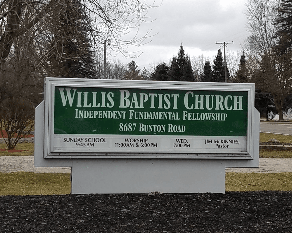 Willis Baptist Church road sign on Bunton Road, listing service times for Sunday School, Worship, and Wednesday Bible study.